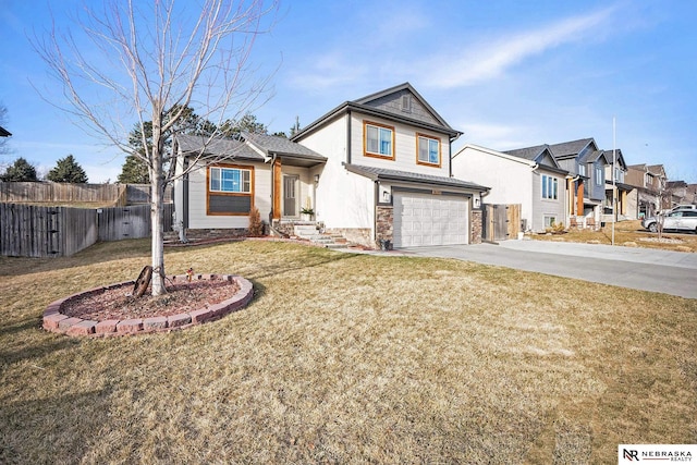 traditional-style house featuring a front lawn, fence, a residential view, a garage, and driveway