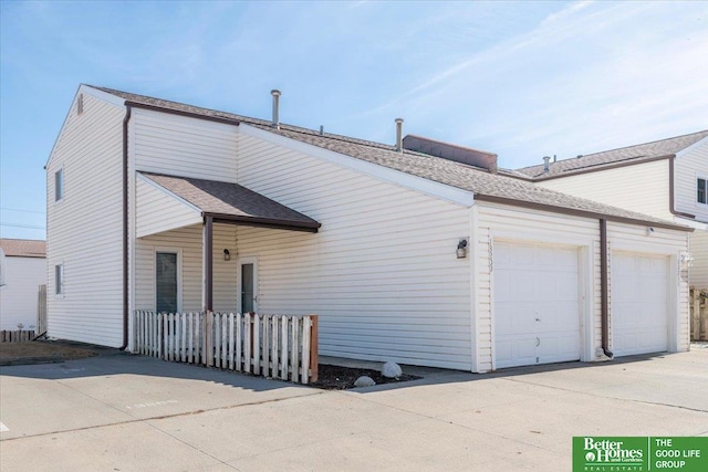 view of front of property with a garage and concrete driveway