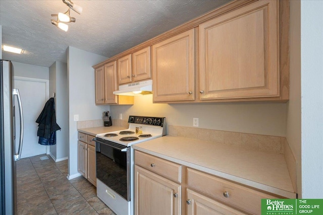 kitchen with white electric range oven, freestanding refrigerator, light brown cabinets, and under cabinet range hood