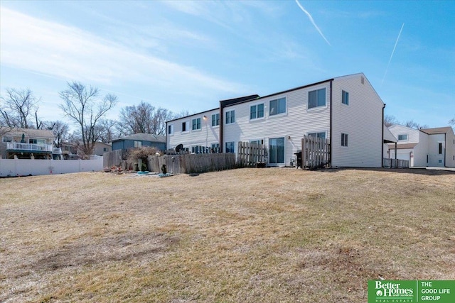 back of property featuring a residential view and fence