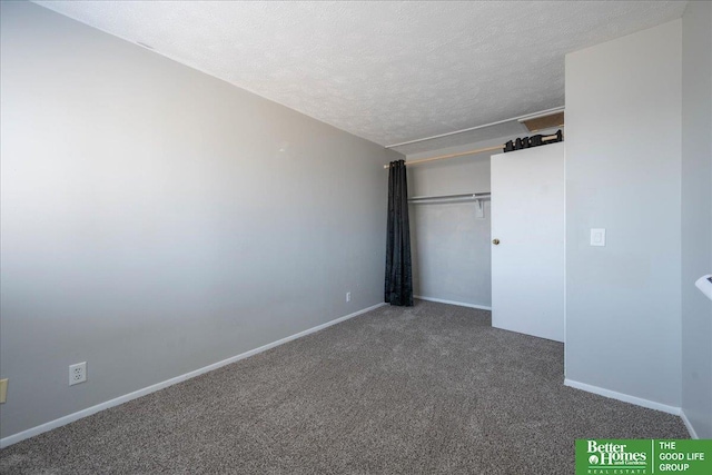 unfurnished bedroom with a closet, carpet flooring, a textured ceiling, and baseboards