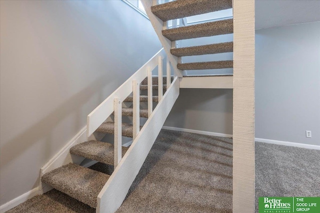 stairway featuring baseboards and carpet floors