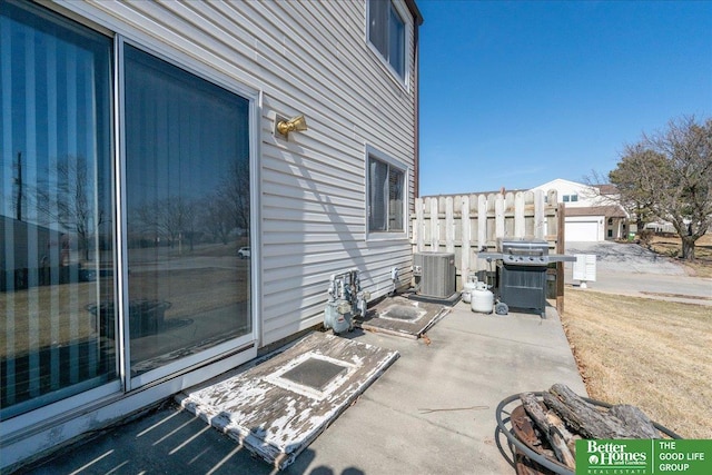 view of patio / terrace featuring cooling unit, area for grilling, and fence