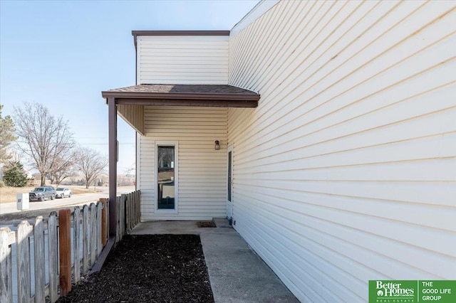 view of side of home featuring fence