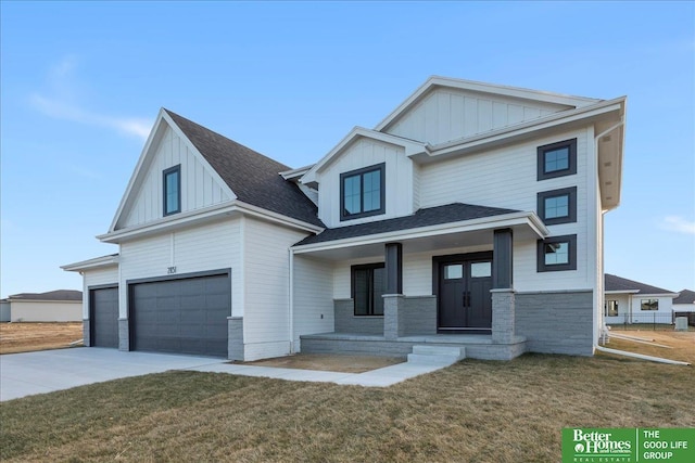 view of front facade featuring driveway, a front lawn, board and batten siding, and an attached garage