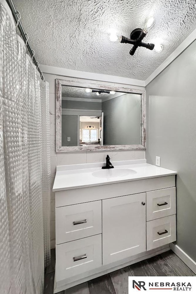 bathroom with a textured ceiling and vanity