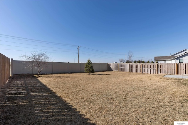 view of yard featuring a fenced backyard