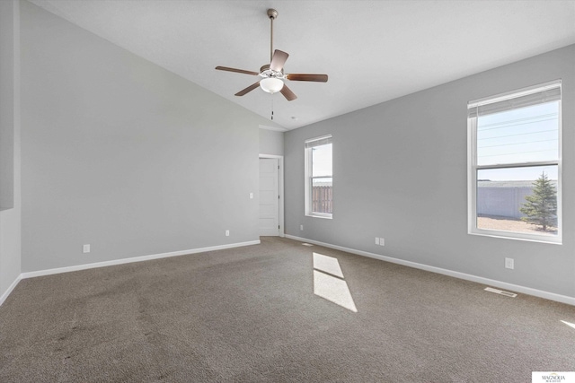 carpeted empty room with baseboards, lofted ceiling, and a ceiling fan