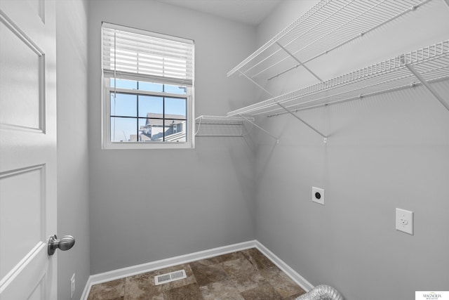 laundry room with visible vents, baseboards, hookup for an electric dryer, and laundry area