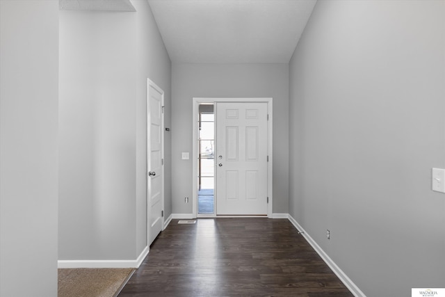 entrance foyer with dark wood finished floors and baseboards