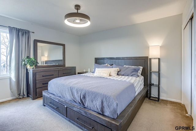 bedroom featuring light colored carpet and baseboards