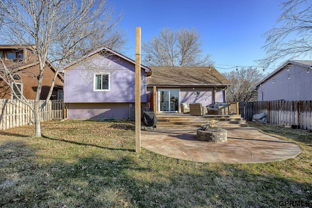 rear view of property with a patio, a fire pit, a lawn, and fence private yard