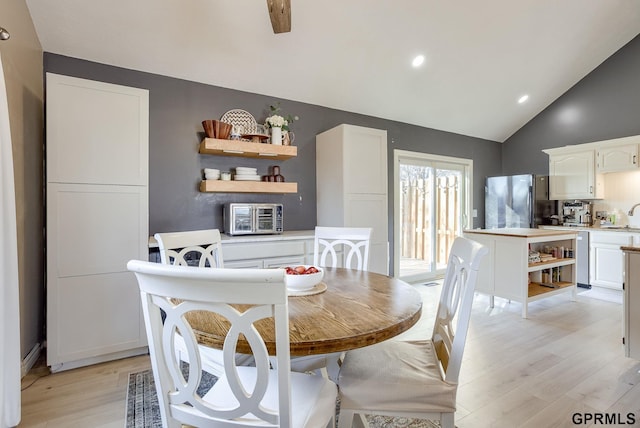 dining room featuring vaulted ceiling, recessed lighting, and light wood-style floors