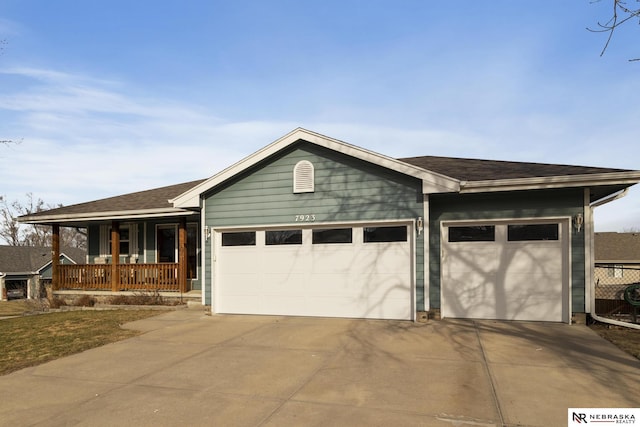 ranch-style house with a porch, concrete driveway, and an attached garage