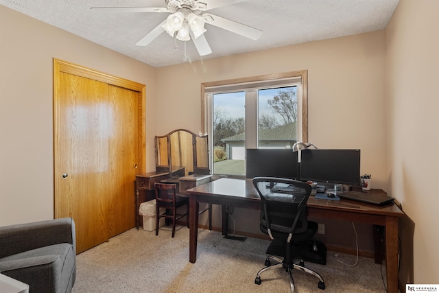 office space featuring a textured ceiling and ceiling fan