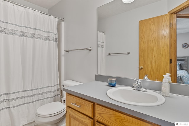 full bathroom featuring toilet and vanity