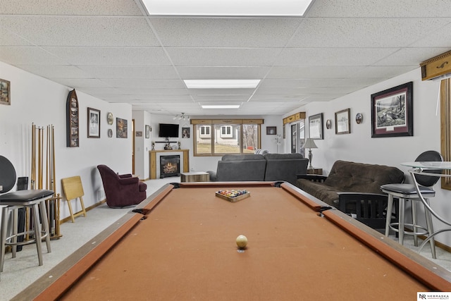 game room with a drop ceiling, billiards, baseboards, and a glass covered fireplace