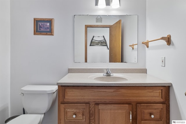 bathroom featuring toilet and vanity