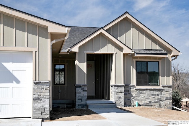 property entrance with stone siding, board and batten siding, a shingled roof, and a standing seam roof