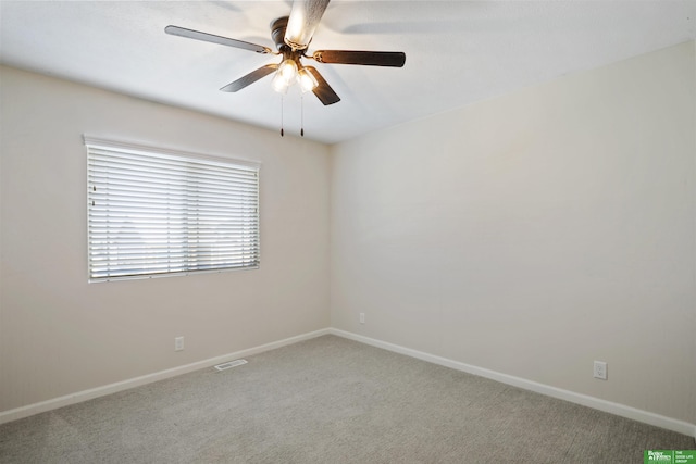 unfurnished room with visible vents, baseboards, carpet, and ceiling fan