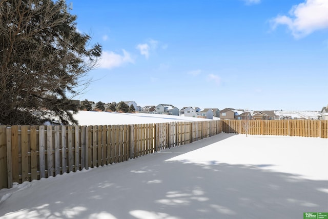 view of yard featuring a residential view and a fenced backyard