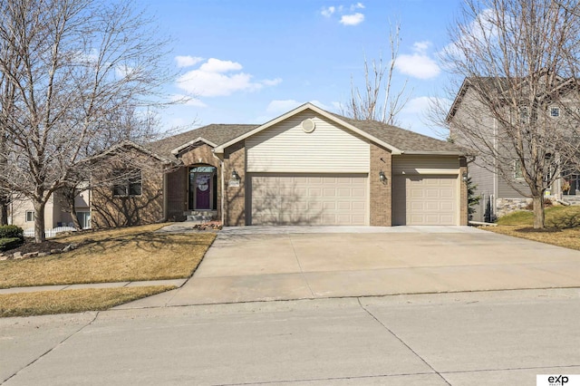 ranch-style home featuring brick siding, concrete driveway, and a garage