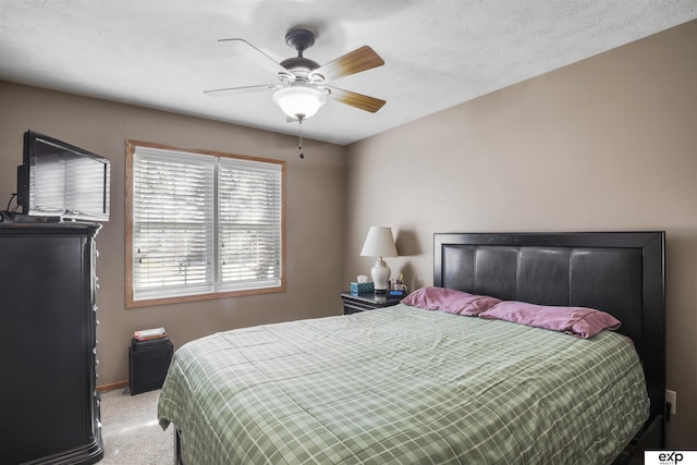 bedroom featuring light carpet, ceiling fan, and baseboards