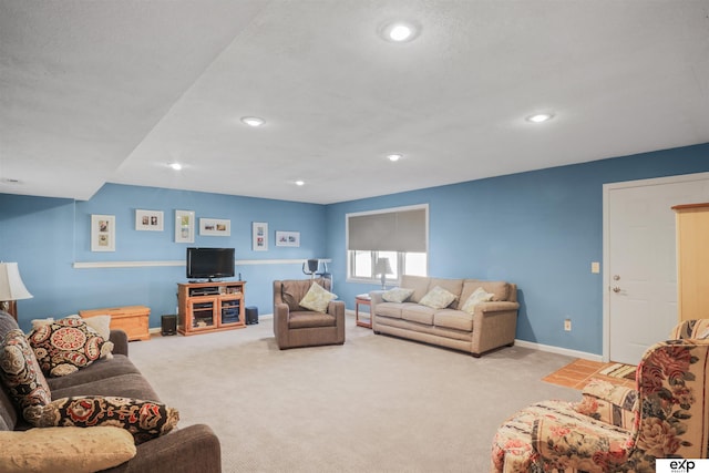 carpeted living area with recessed lighting and baseboards