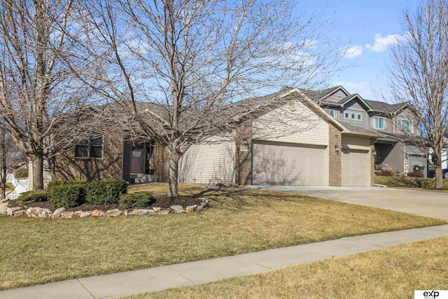 view of front of house featuring a garage, brick siding, concrete driveway, and a front yard