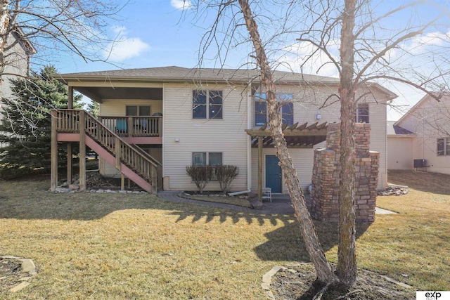 rear view of house with stairs, central air condition unit, a deck, and a lawn