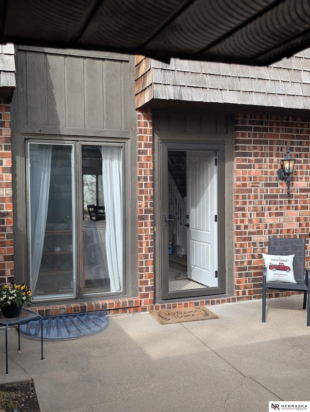 doorway to property with brick siding