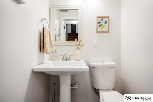 bathroom featuring visible vents and toilet