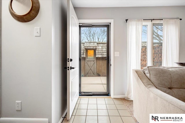 entryway featuring light tile patterned floors and baseboards