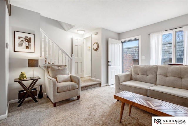 living room featuring stairway, light colored carpet, and baseboards