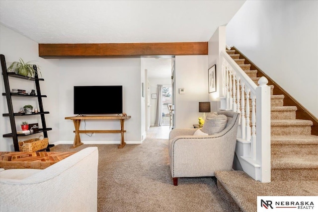 living area with beam ceiling, stairway, carpet flooring, and baseboards