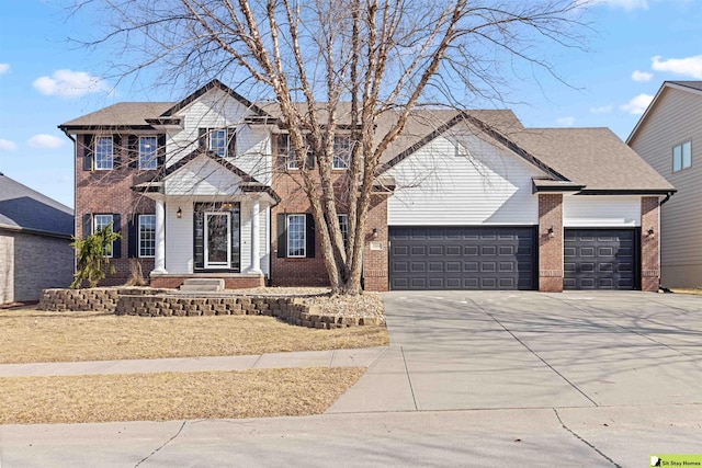 view of front of property with a garage, brick siding, and driveway