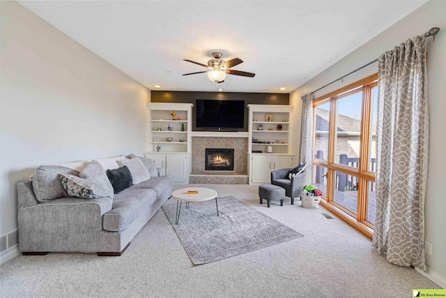 carpeted living area with a glass covered fireplace, recessed lighting, a ceiling fan, and baseboards