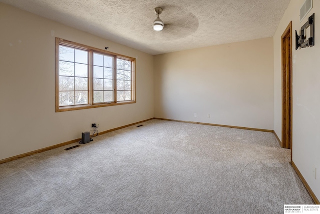 unfurnished room featuring visible vents, light colored carpet, and baseboards