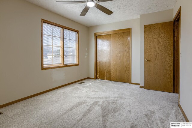 unfurnished bedroom with baseboards, visible vents, carpet floors, a closet, and a textured ceiling