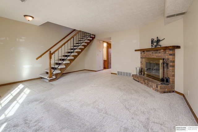 unfurnished living room featuring visible vents, a textured ceiling, a fireplace, carpet flooring, and stairs