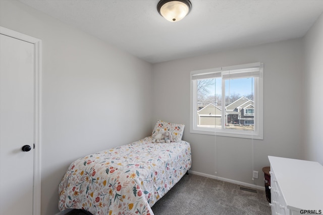 carpeted bedroom with baseboards and visible vents