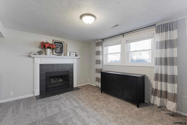 living room with visible vents, light carpet, baseboards, and a tile fireplace