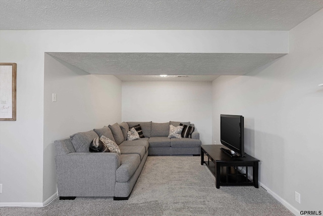 living area with baseboards, a textured ceiling, and carpet flooring