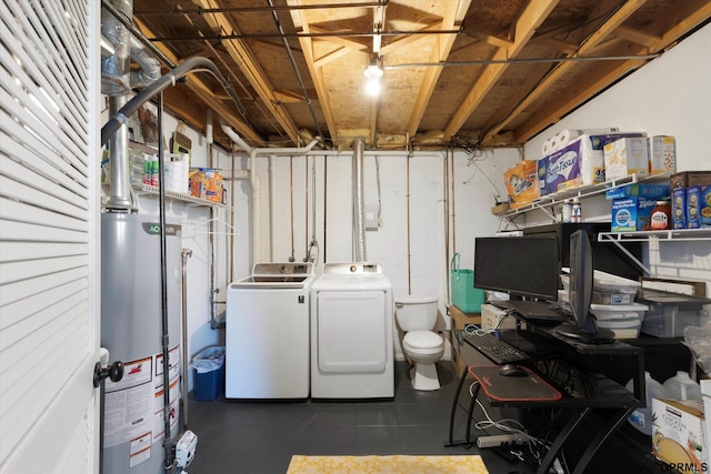 washroom with washer and clothes dryer, laundry area, gas water heater, and tile patterned flooring