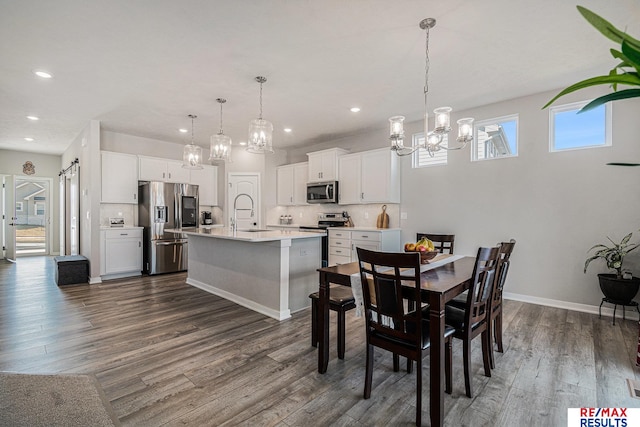 dining area featuring recessed lighting, baseboards, an inviting chandelier, and dark wood-style flooring