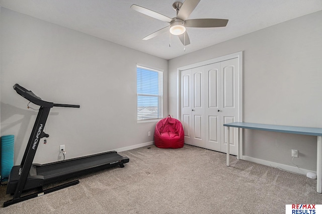 workout room featuring baseboards, a ceiling fan, and carpet flooring