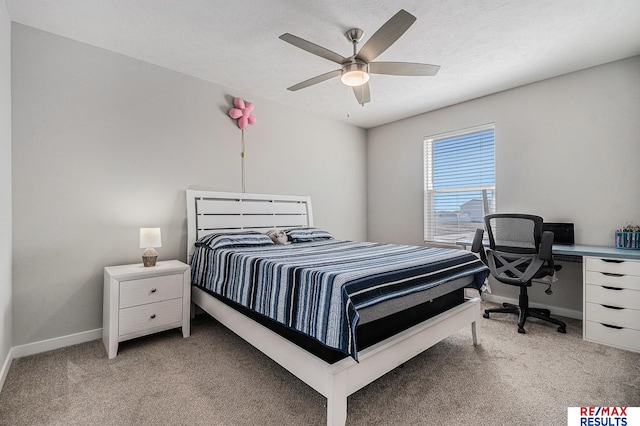 bedroom with a ceiling fan, light colored carpet, baseboards, and a textured ceiling