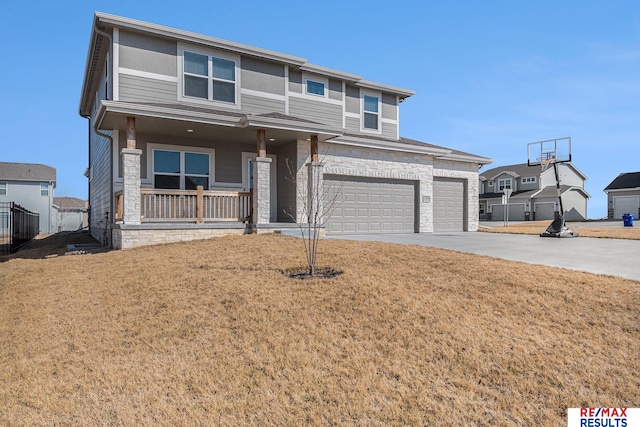 view of front of property featuring a porch, an attached garage, a front lawn, and driveway