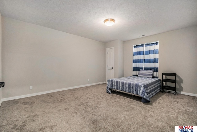 carpeted bedroom featuring visible vents, baseboards, and a textured ceiling