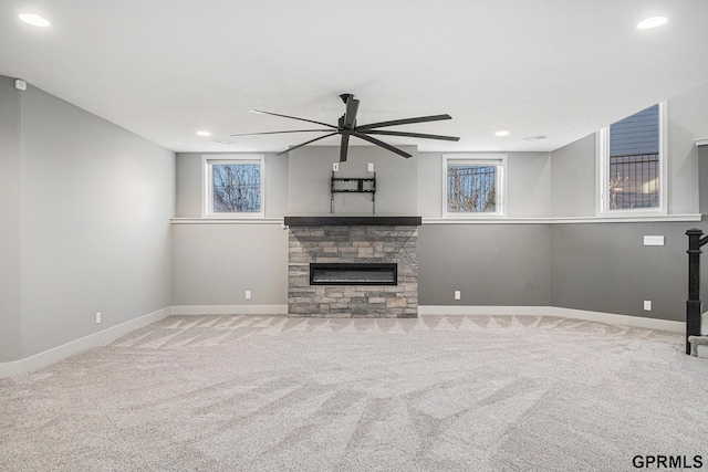 unfurnished living room featuring baseboards, ceiling fan, carpet floors, recessed lighting, and a fireplace